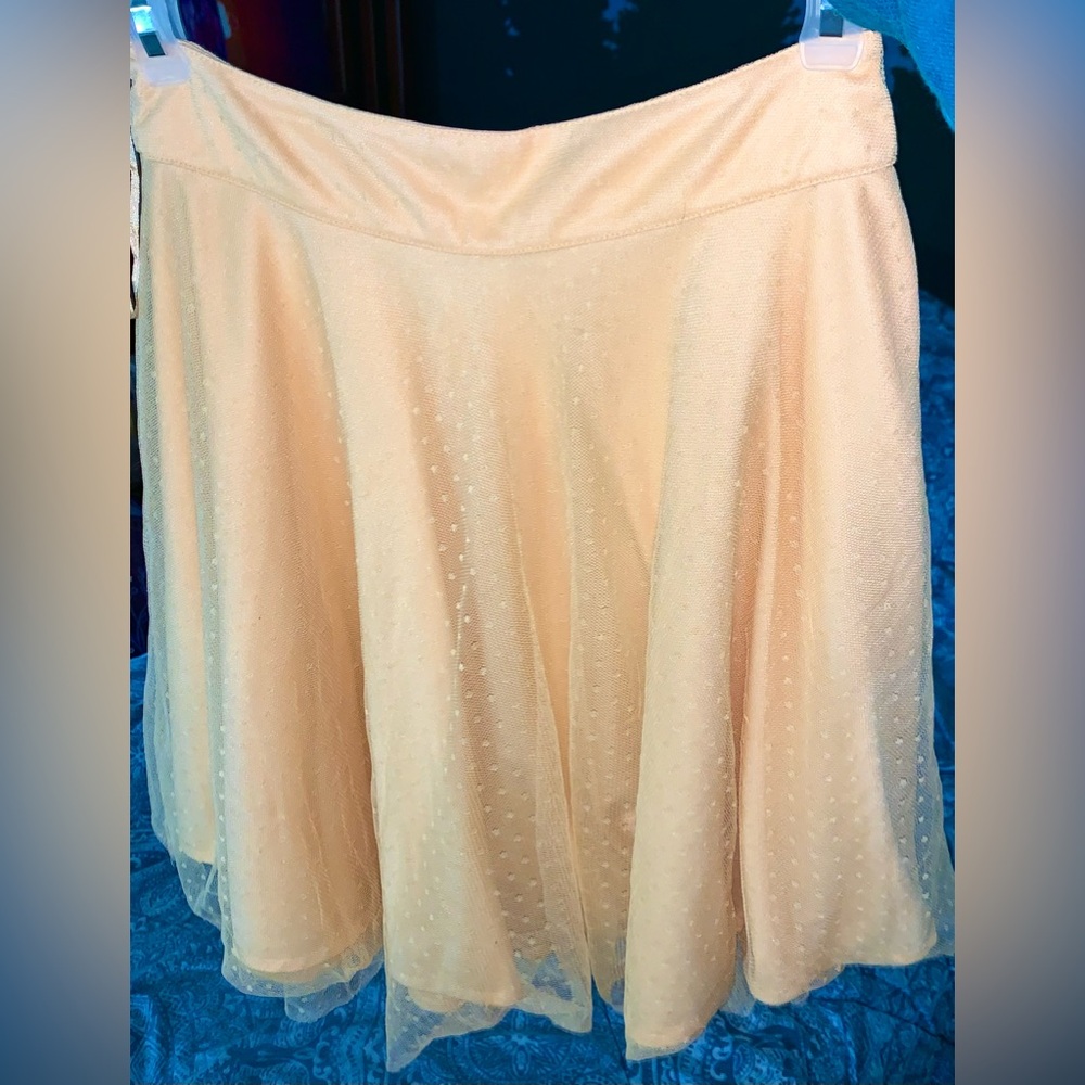 small peach coloured skirt with subtle polka dots